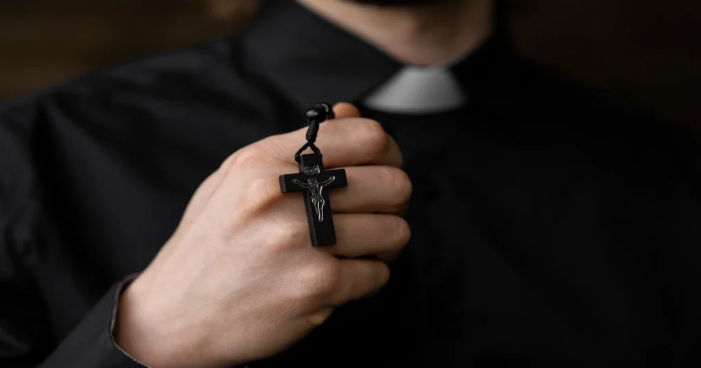 close up priest holding rosary 2