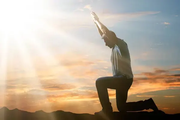 depositphotos 211208954 stock photo side view man kneeling praying