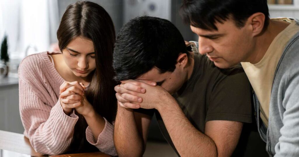 front view people praying together kitchen 1